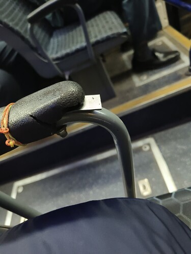 A close-up of a worn-out seat handle in a bus. (Captioned by AI)