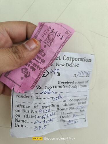 A hand holds a pink Delhi Transport Corporation ticket and a receipt for a two hundred rupee fine for traveling without a ticket. (Captioned by AI)