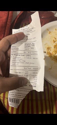 A receipt for a mushroom tikka biryani from The Mughal Trail. (Captioned by AI)